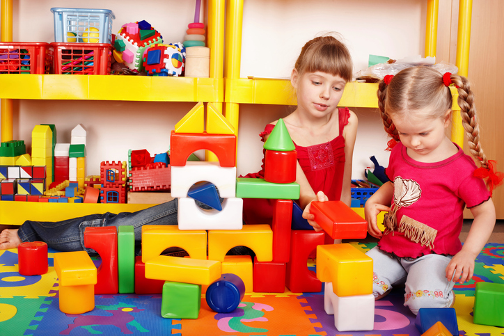Two children playing together with some blocks
